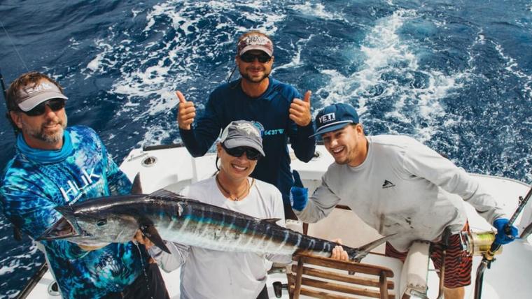 Sport fishing boat with rods rigged heading offshore from St. Croix