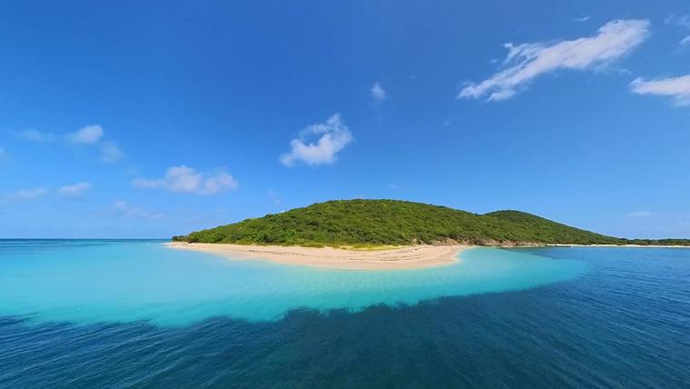 Aerial view of Buck Island, its white-sand point and the turquoise shallows off St. Croix