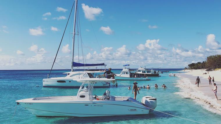 Boats anchored in turquoise water off the white sand at Buck Island
