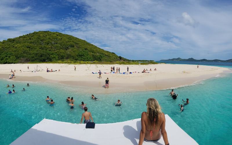 Guests at the bow of Mile Mark arriving at the beach on Buck Island