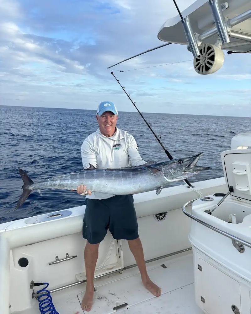 Day Break Charters angler holding a wahoo on a St. Croix fishing boat