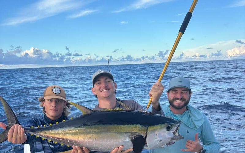 An angler on a St. Croix fishing charter holding up a wahoo