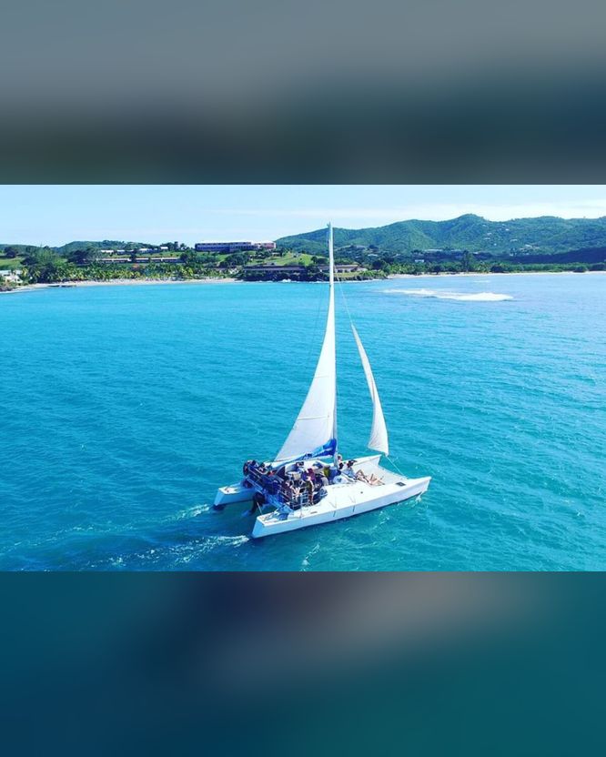 Wave Dancer sailing catamaran under full sail on the full day sail to Buck Island