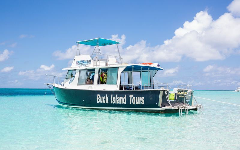 Mile Mark anchored in clear water off a Buck Island beach