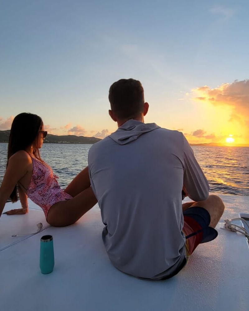 Guests watching the sun set over the Caribbean on a St. Croix sunset cruise