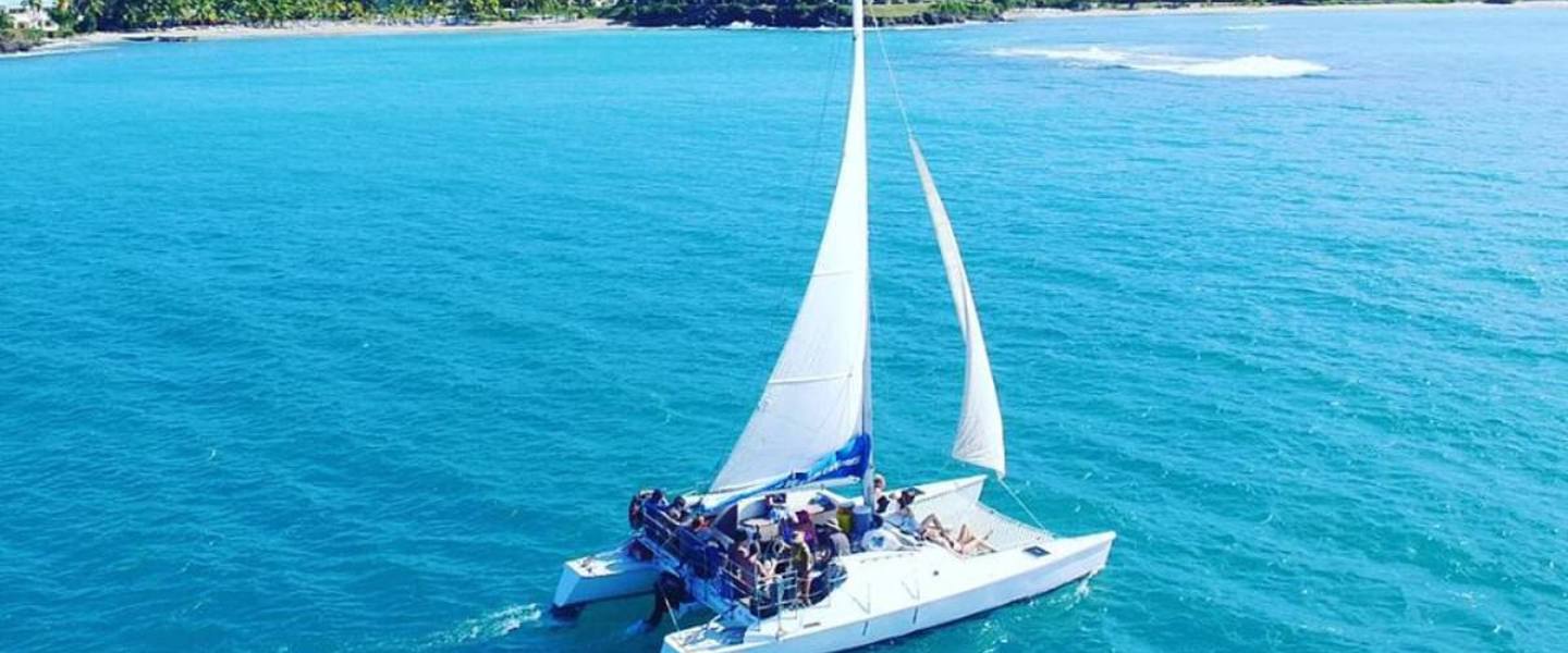 Aerial view of the Wave Dancer sailing catamaran under sail with guests aboard off St. Croix