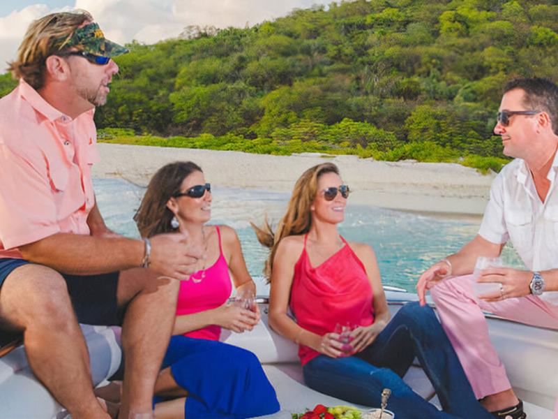 Two couples sharing drinks aboard Smooth Recovery