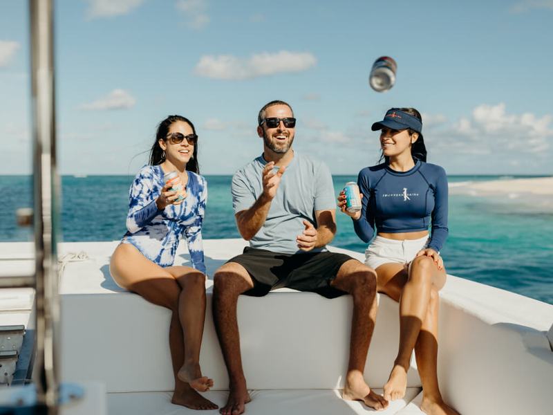 Friends relaxing on the plush seating aboard Celebration