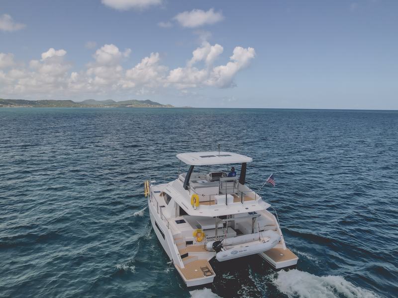 Good Times power catamaran with the St. Croix coastline behind