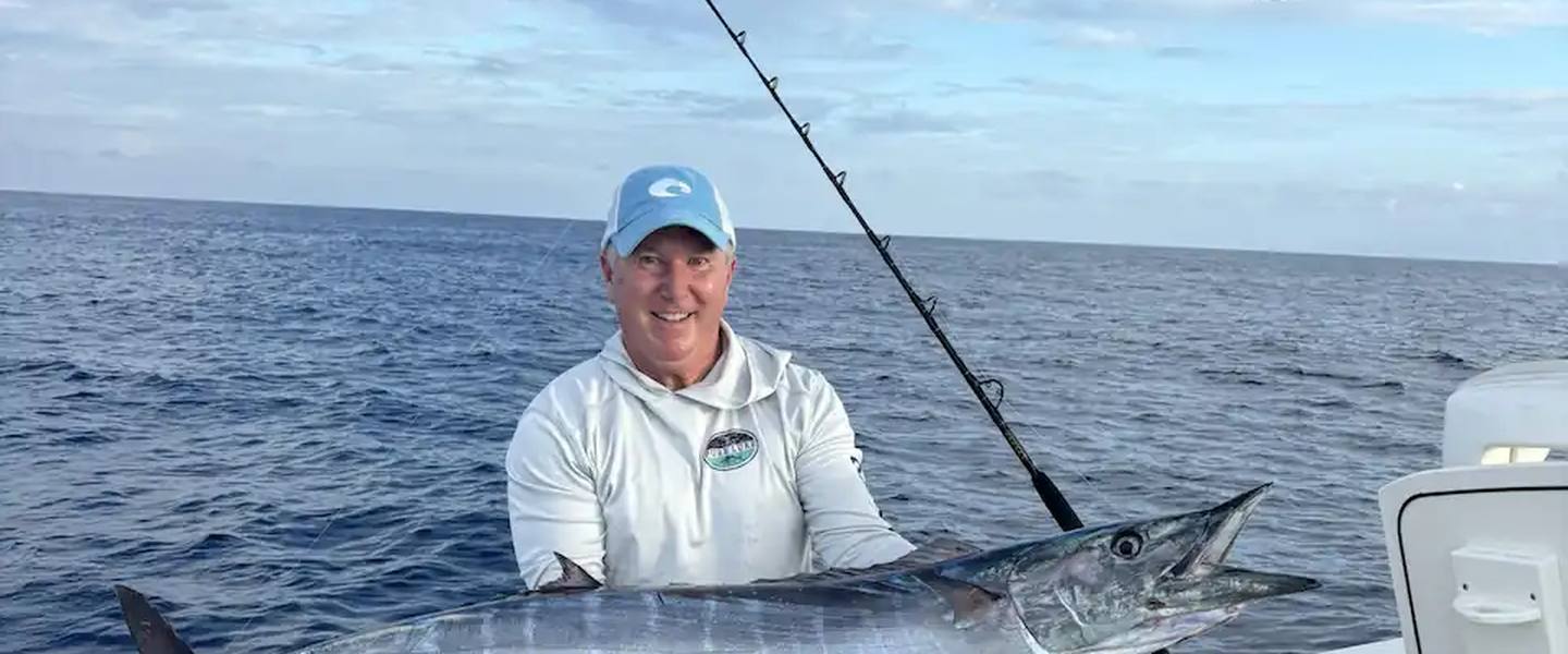 Day Break Charters angler holding a wahoo on a St. Croix fishing boat