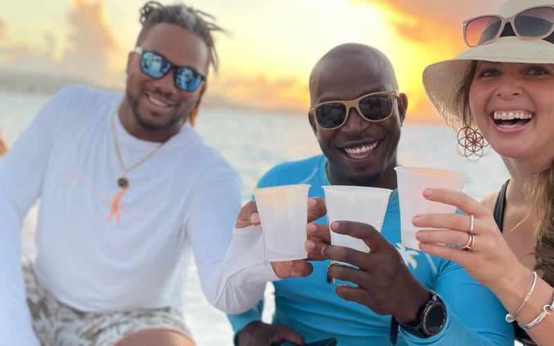 Friends toasting at sunset on a Celebration private sunset cruise