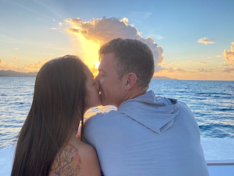 A couple sharing a kiss at sunset on a St. Croix sunset cruise