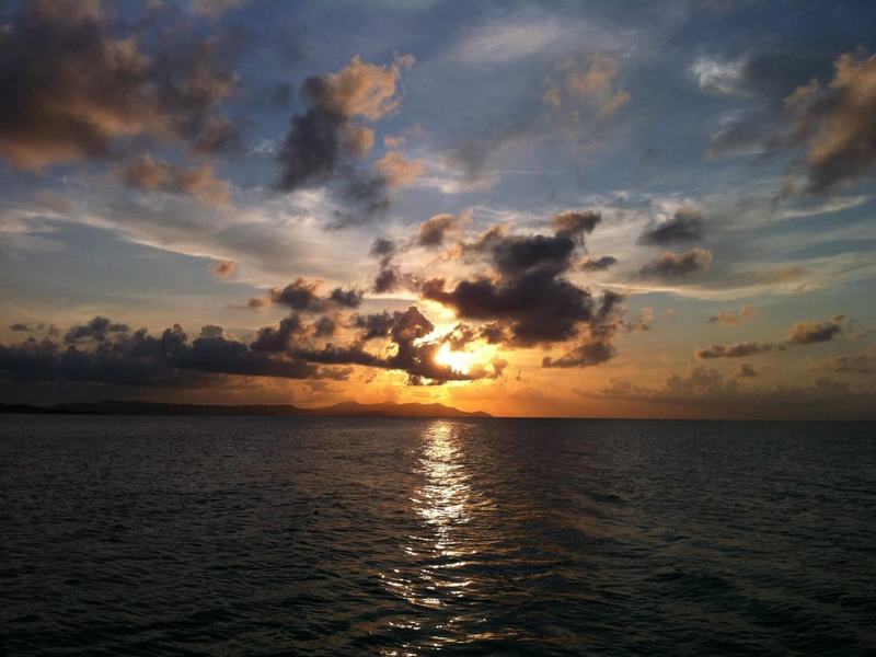 The sun setting through clouds over the Caribbean Sea off St. Croix